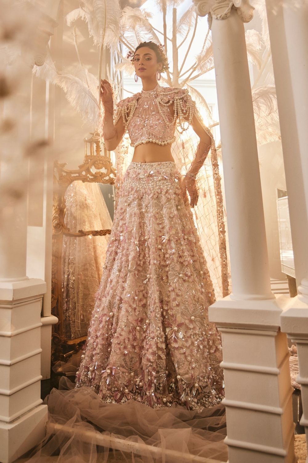 Juventas Baby Pink Embellished Net Lehenga and Halter Blouse with Trail