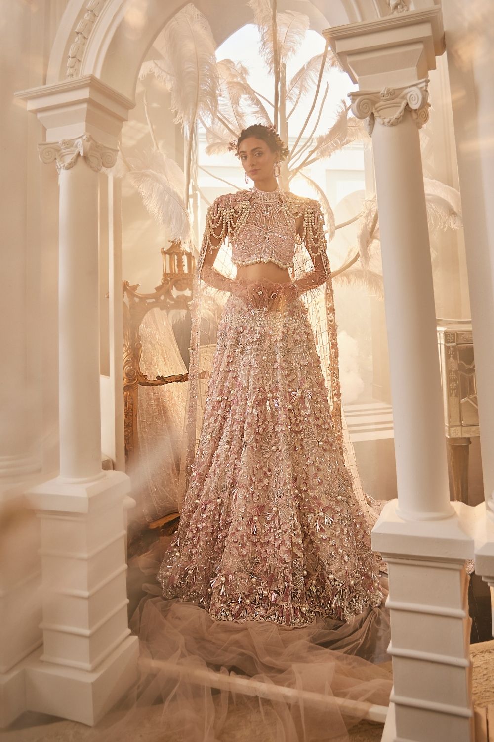 Juventas Baby Pink Embellished Net Lehenga and Halter Blouse with Trail